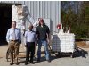Panneer Selvam, center, Micah Hale, left, and Matt Strasser display the thermocline energy storage test system outside the Engineering Research Center in south Fayetteville