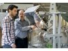 The researchers Christian Wieckert and Nikolaos Tzouganatos during work at the solar reactor. Photo: Paul Scherrer Institute/Markus Fischer.